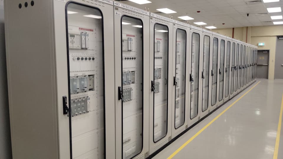 Rows of electrical control panels in an industrial control room